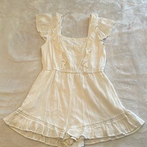 Super adorable white romper! Lace and frill detailing.